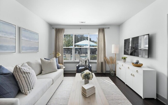 Contemporary Apartment Living Room with Plush Sofa and Accent Chair - The Landing at Vinnin Square