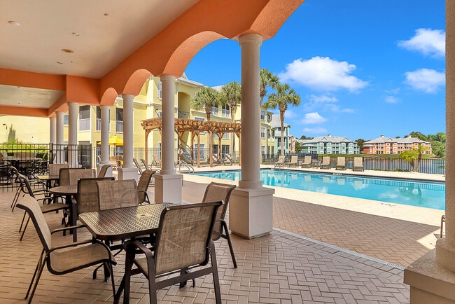 Pool with Covered Patio & Seating - Bermuda Estates at Ormond Beach