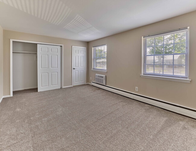 Bright and roomy bedroom with plush carpet and ample closet space at Maple Terrace Apartments in Maple Shade, NJ - Maple Terrace