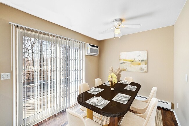 Formal dining room with ceiling fan and doorwall - The Gables of Troy