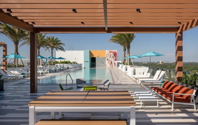 Indulge in the Miami sun on our expansive pool deck, offering luxury seating - Core At Link