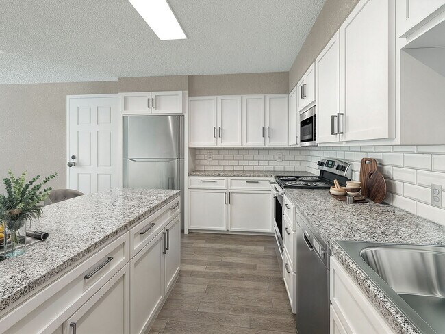 Kitchen with granite counters, stainless appliances, and modern cabinetry - Vetra Hurstbourne