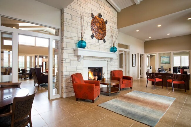 Step into the inviting common area of SunStone at Fox Ridge, where contemporary design meets warmth. Enjoy gatherings by the cozy fireplace or relax in stylish seating. Your ideal living space awaits—schedule a tour today! - SunStone at Fox Ridge
