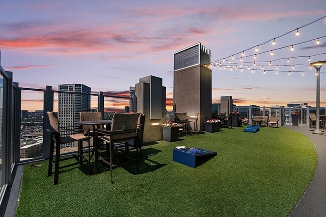 Enjoy a game of cornhole on the SkyDeck rooftop - SkyHouse Dallas Apartments