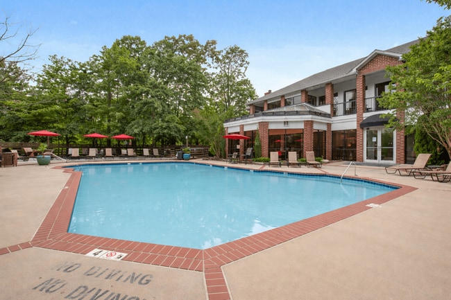 Pool Side Relaxing Area Surrounded by Trees - Rolling Brook Village