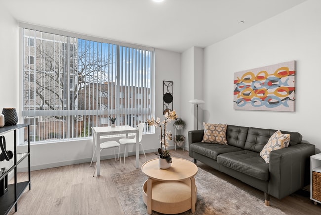 Light-filled living space with modern décor and expansive windows. - The Ruby