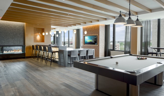 Connect, relax, and play in our stylish club room. A hub of community and comfort - Flats 8300 Apartment Homes